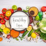 top-view-healthy-life-inscription-spiral-notebook-white-pot-collection-fresh-vegetables-vegetarian-dinner-cooking-white-background_140725-143139